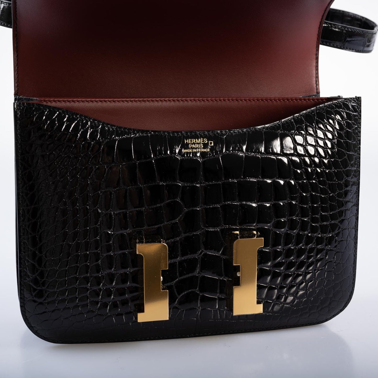 Hermès Constance 24 Verso Shiny Black Alligator and Rouge H with Gold Hardware